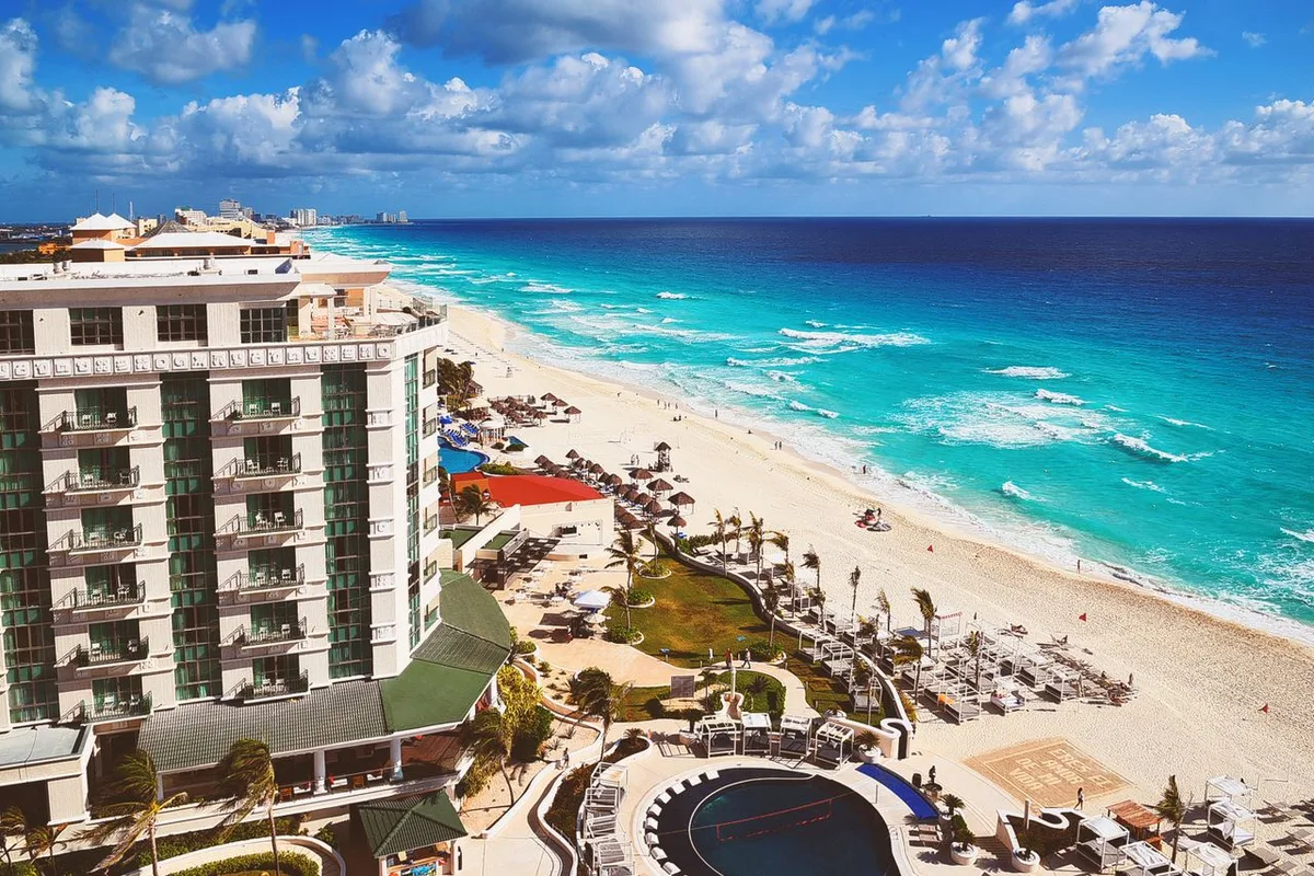 An aerial view of a beachfront resort hotel on the turquoise coast of Cancún, Mexico